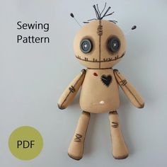 an image of a sewing pattern for a doll with buttons on it's head