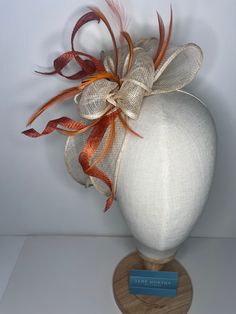 Orange & cream high-quality sinamay bow attached to coordinating headbands for easy wear. Each fascinator is crafted by hand, ensuring that no two pieces are exactly alike. Our bow design fascinators are available in a variety of colors to match any outfit. Whether you're looking for a bold pop of color or a subtle neutral tone. 🖤This head piece looks simply stunning and is perfect for weddings, special occasions or a day at the races.  🖤All head pieces are finished with matching headband wrapped in co-ordinating silk ribbon or secure millinery elastic which is comfortable and easy hidden. 🖤Shipped in a sturdy (keepsake) box and packed with special love and care.  🖤Made in the UK - customised fascinator orders are welcome. Please send me a message and we can create something unique.  T Adjustable Bow Headband For Weddings, Adjustable Wedding Fascinator With Satin Bow, Elegant Orange Fascinator For Wedding, Adjustable Wedding Hair Accessories With Decorative Bow, Adjustable Wedding Headband With Bow, White Bow Fascinator For Wedding, Adjustable Bow Hair Accessories For Wedding, White Bow Headband For Wedding, Adjustable Ribbon Headpiece For Wedding