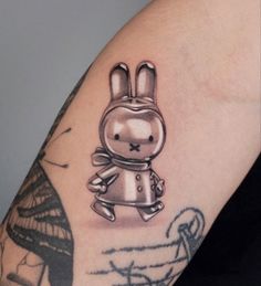 a tattoo on the arm of a person with a rabbit in it's head