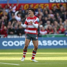 a rugby player holding his fist up in celebration