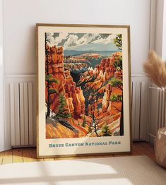 an old poster hangs on the wall next to a vase with dried grass in it