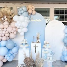 a blue and white dessert table with balloons