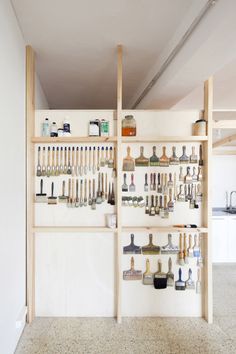 the shelves are filled with tools and other items in this white room that is well organized