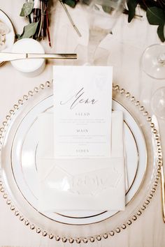 a place setting with white plates and silverware