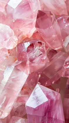 pink crystals are scattered on top of each other in this close - up photo taken from above