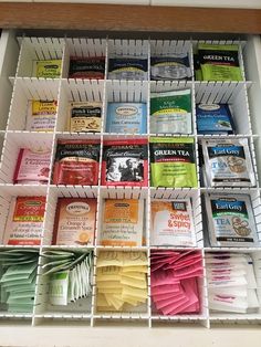 a drawer filled with lots of different types of teas and coffee bags on top of each other