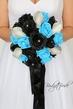 a bride holding a black and blue bouquet