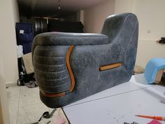 an inflatable couch sitting on top of a table next to other furniture and tools