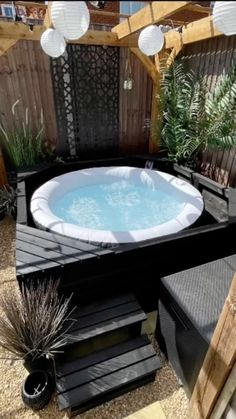 an outdoor hot tub in the middle of a garden