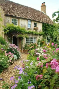 a house with lots of flowers in front of it