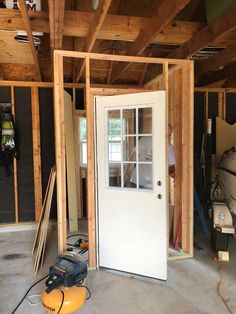 the inside of a house being built with wood framing and tools on the floor next to it