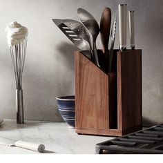 a kitchen utensil holder with spoons and spatulas