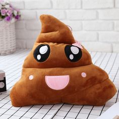 a brown poop shaped pillow sitting on top of a table