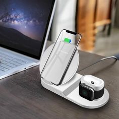 an iphone charging station on top of a laptop