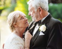 an older man and woman embracing each other