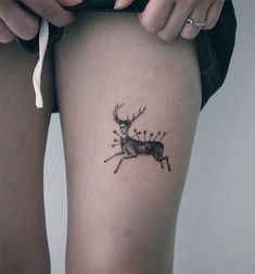 a woman's thigh with a tattoo of a deer on it