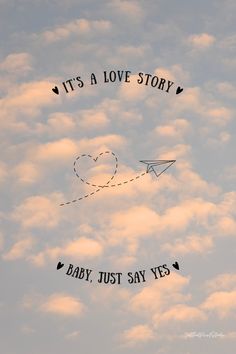 an airplane is flying through the sky with it's love story written on it