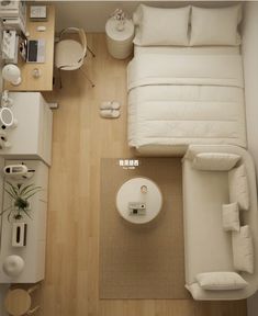 an overhead view of a living room with white furniture and accessories on the wood floor