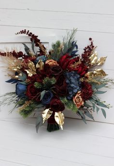 a bouquet of flowers sitting on top of a white wall