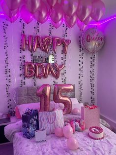 a birthday party with balloons, presents and gifts on a bed in a room that is decorated for someone's 21st birthday