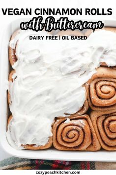 vegan cinnamon rolls with white frosting in a baking dish