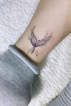 a woman's foot with a flower tattoo on her left ankle and the bottom part of her leg