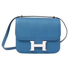 100% authentic Hermès Constance 18 mini shoulder bag in Bleu Azure Veau Epsom leather. Palladium H buckle closure. Lined with Veau Swift leather. The interior is divided into two compartments, with an open pocket on the front and back. Has been worn and has some scratches on hardware and flap. Overall in excellent condition. Comes with dust bag. Measurements Height 14.5cm (5.7in) Width 18cm (7in) Depth 5cm (2in) Drop of the Handle 27cm (10.5in) Hardware Palladium Blindstamp C (2018) All our list Hermes Constance Bag Blue, Hermes Blue Bag, Chanel Mini Rectangle, Mini Constance, Gucci Jackie 1961, Hermes Constance Bag, Chanel Denim, Chanel Gabrielle, Fendi Vintage