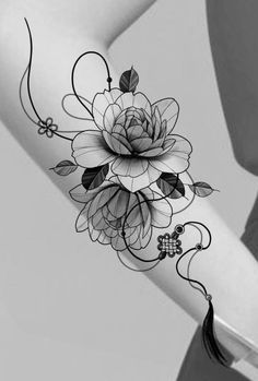 a black and white photo of a woman's arm with flowers on it