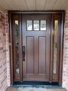 the front door is made of wood and has two sidelights on each side,