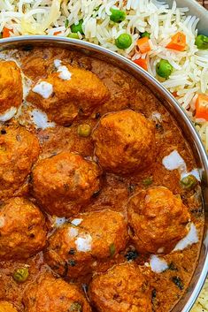 meatballs and rice are served in a large metal bowl on top of a wooden table