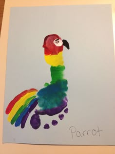 a child's drawing of a colorful bird with the word parrot painted on it