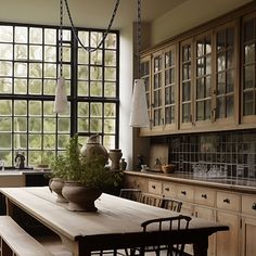 a large kitchen with wooden cabinets and windows