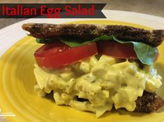 an egg salad sandwich is on a yellow plate