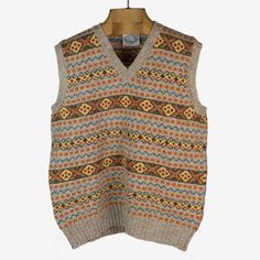 "The Duke" Fair Isle sweater vest, greige, orange, brown & blue | No Man Walks Alone Brown Knit V-neck Vest, Brown V-neck Vest For Winter, Brown Knit V-neck Sweater Vest, Brown V-neck Knit Sweater Vest, Brown V-neck Sweater Vest, Classic Beige Wool Sweater Vest, Retro V-neck Winter Vest, Casual Knitted Wool Vest, Classic Brown Wool Sweater Vest