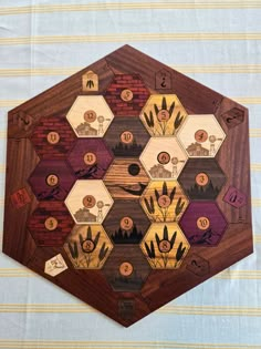 a hexagonal wooden board with many different types of animals and plants on it