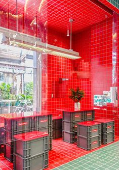 a red tiled kitchen with lots of storage containers