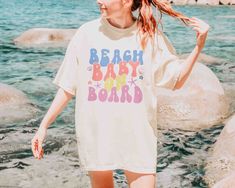 Beach Baby On Board Shirt - Mod Reveals Soft-washed Summer Beach T-shirt, Cute Summer Beach T-shirt, Cute White Beach T-shirt, Beachy T-shirt For Beach Party, Playful Soft-washed Tops For Summer, Playful Soft-washed Summer Tops, Soft-washed White T-shirt For Beach, Cute Relaxed Fit T-shirt For Beach Season, Beachy Funny Print T-shirt For Beach