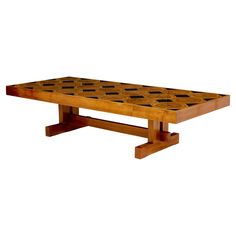 a wooden table with black squares on it's top and legs, against a white background