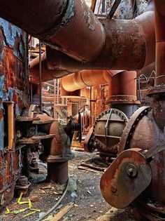 an old factory with rusty pipes and machinery