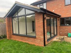 a brick house with an open patio and sliding glass doors