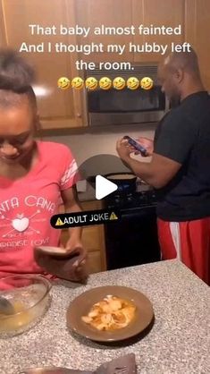 two people are in the kitchen and one is looking at her phone