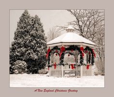 a gazebo covered in christmas wreaths and red bowes is surrounded by snow