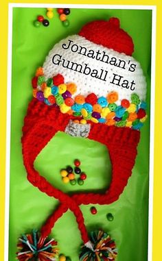 a crocheted hat with pom poms on it and the words jonathan's gumball hat