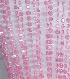 pink sequins hanging from the side of a curtain