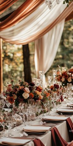 Romantic fall wedding table decor featuring elegant floral arrangements and draped fabrics in autumn colors. Perfect for fall wedding ideas and inspirations. Wedding Decor Small Spaces, Fall Wedding Centerpieces With Pumpkins Wedding Table Decor, Elegant Fall Wedding Table Decor, Cinnamon Wedding Flowers, Classic Style Wedding Decor, October Wedding Table Settings, Fall Wedding Set Up, Fall Wedding Reception Table Decorations, Fall Long Table Centerpieces