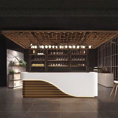 an empty bar with stools and bottles on the wall behind it in a dark room