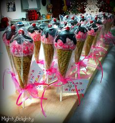 ice cream cones with chocolate frosting and sprinkles in plastic wrappers