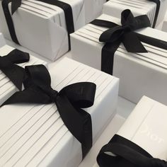 several white boxes with black ribbons tied around them