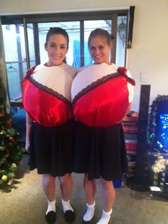 two girls dressed in costumes standing next to each other with large pillows on their backs