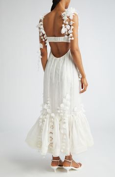 Encased in corsetry, this romantic linen-and-silk gown is softened with cascades of fluttery organza petals and a bouffant flounce edged with delicate fringe. 39" center front length (size OP/2) Hidden back zip; back strap with hook-and-eye closure Sweetheart neck Adjustable tie spaghetti straps Lined 53% linen, 47% silk Dry clean Imported Designer Clothing